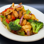 Chicken stir fry. Sautéed with peppers, onions, tomatoes, broccoli, and soy sauce